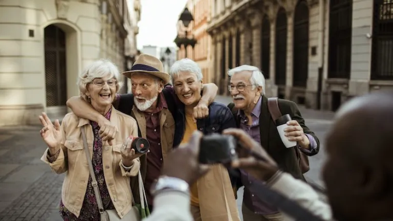 Close up of a group of seniors taking pictures while exploring the city
