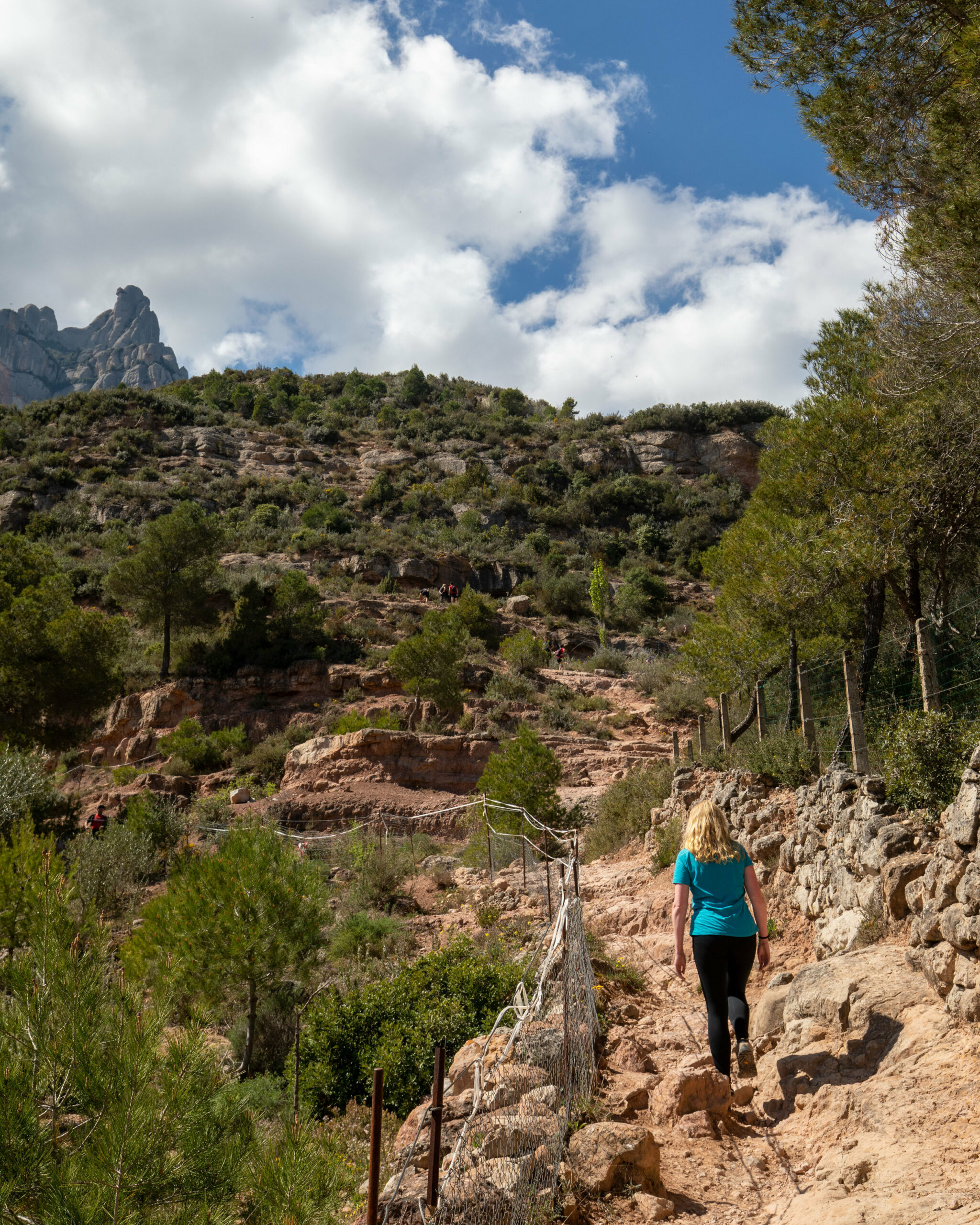 photo of an expat woman hiking to montserrat monastery outside of barcelona spain