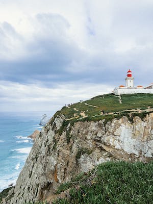 visiting sintra, portugal to see lighthouse on a cliff